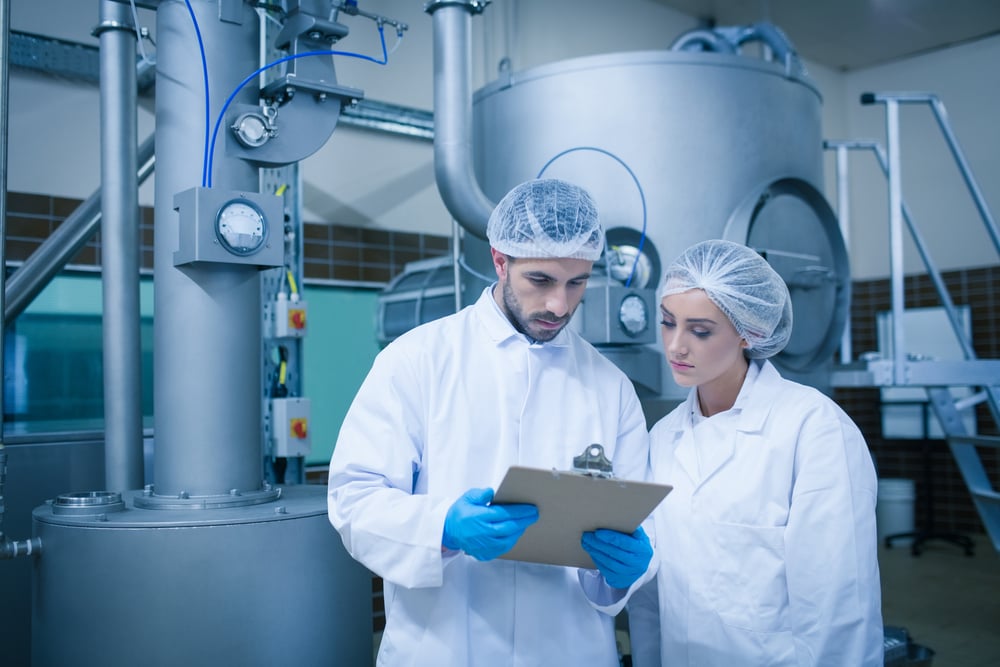 Food technicians working together in a food processing plant 1 2